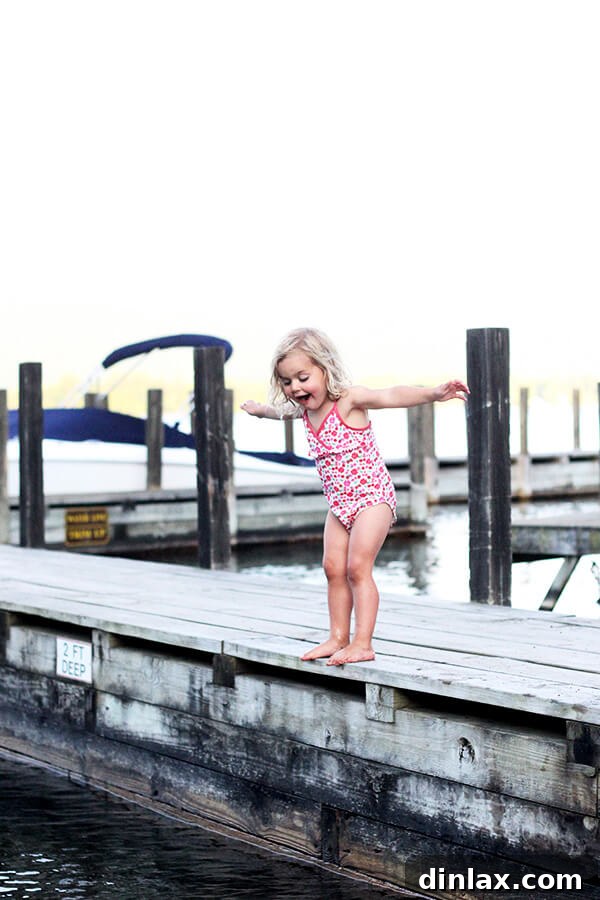 Wren's joyful leap into Lake George Wren gracefully jumping into the calm waters of Lake George, a moment of childhood exuberance and pure delight.