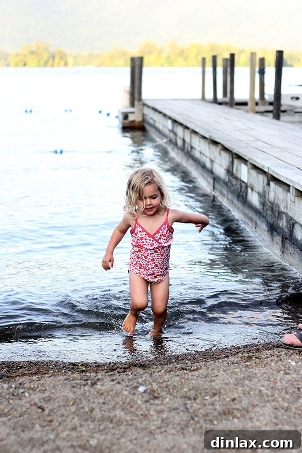 Splashing fun in Lake George Another vibrant snapshot of a child splashing and playing happily in the refreshing lake water, embodying summer fun.