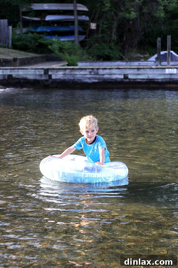 Graham enjoying the lake Graham happily wading in the shallow, clear waters of Lake George, completely absorbed in his joyful play.