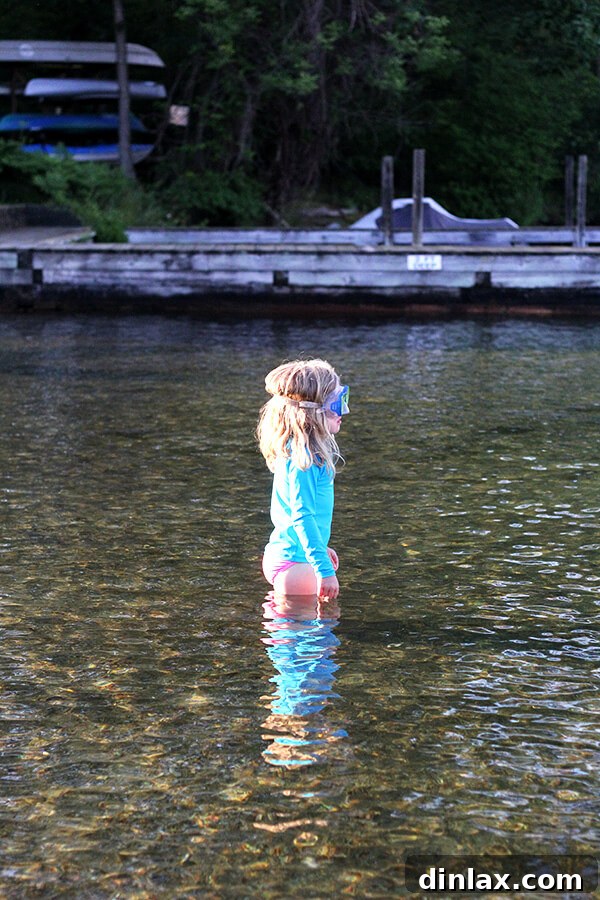 Ella's underwater adventure Ella looking curiously with her swim goggles perched on her head, ready to explore the fascinating depths of Lake George.