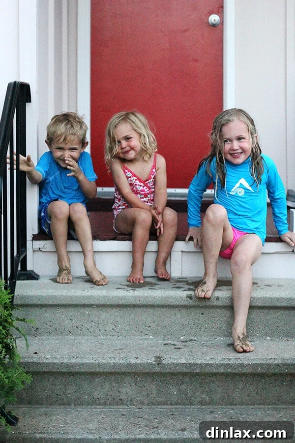 Siblings by the lake Three children enjoying their time together in the serene and clear waters of Lake George, a perfect scene of sibling bonding.
