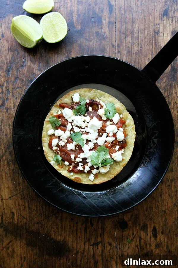 Delicious roasted red pepper and goat cheese wraps, garnished with fresh cilantro and a squeeze of lime.