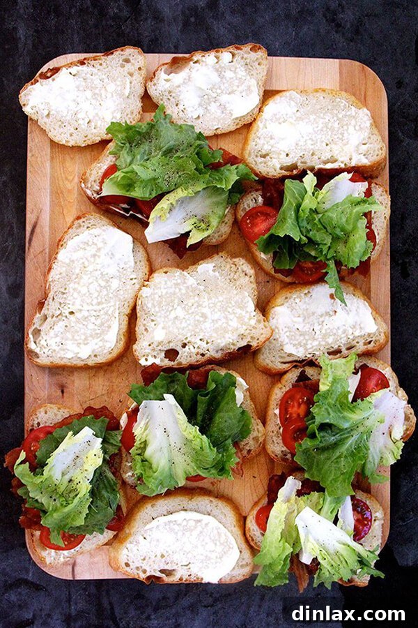 Golden Orecchiette with Zucchini and Sweet Corn 3 Close-up of freshly made BLT sandwiches, featuring ripe red tomatoes, crisp green lettuce, and perfectly cooked bacon, nestled between slices of toasted bread.