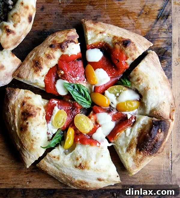 A mouthwatering freshly baked pizza adorned with vibrant roasted red peppers and succulent tomatoes, capturing the essence of summer flavors.