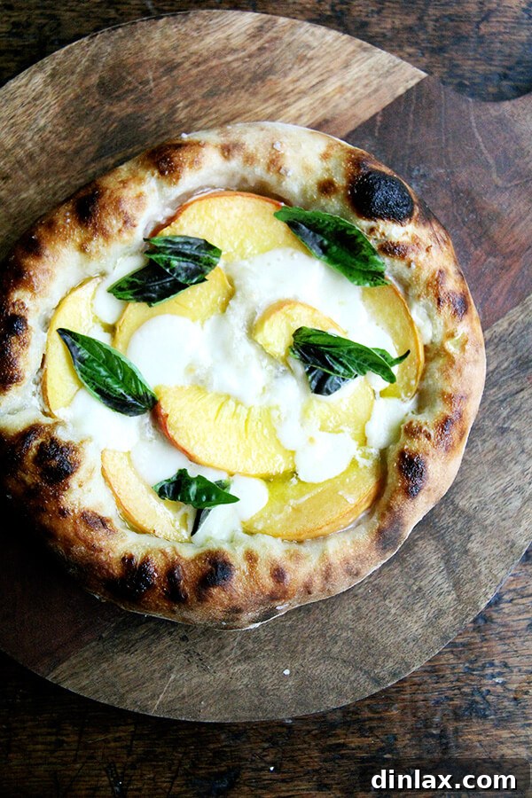 A truly tempting summer pizza featuring sweet, juicy peaches and fresh aromatic basil, perfectly baked with a creamy base.