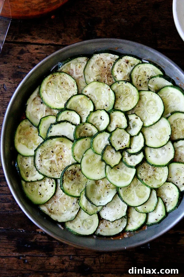 The final layer of zucchini, sauce, and cheese before adding the breadcrumb topping.