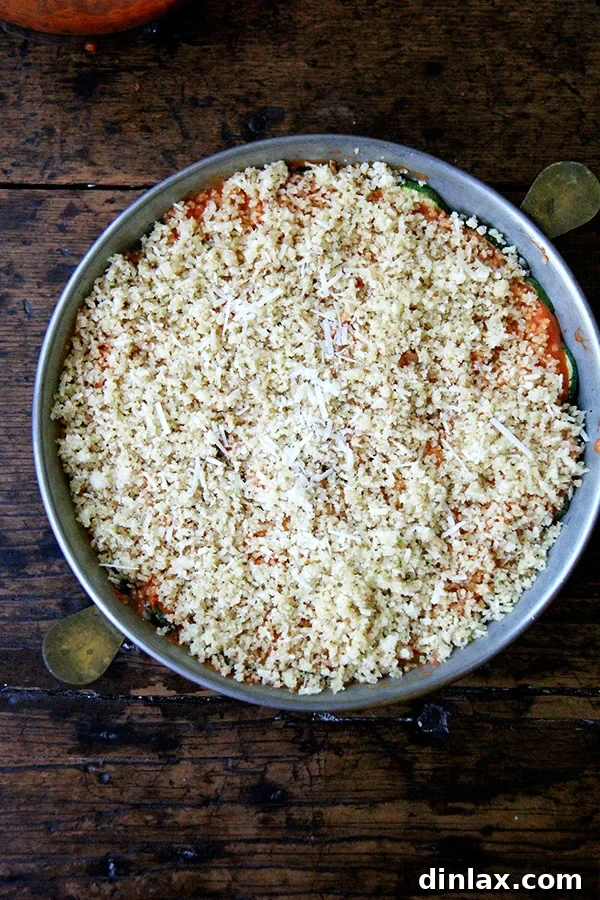 Zucchini Parmesan topped with breadcrumbs, ready to go into the oven.