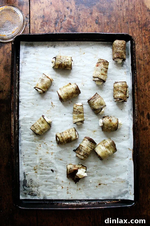 Eggplant involtini rolls, neatly arranged and ready for baking, showcasing the beautiful preparation.