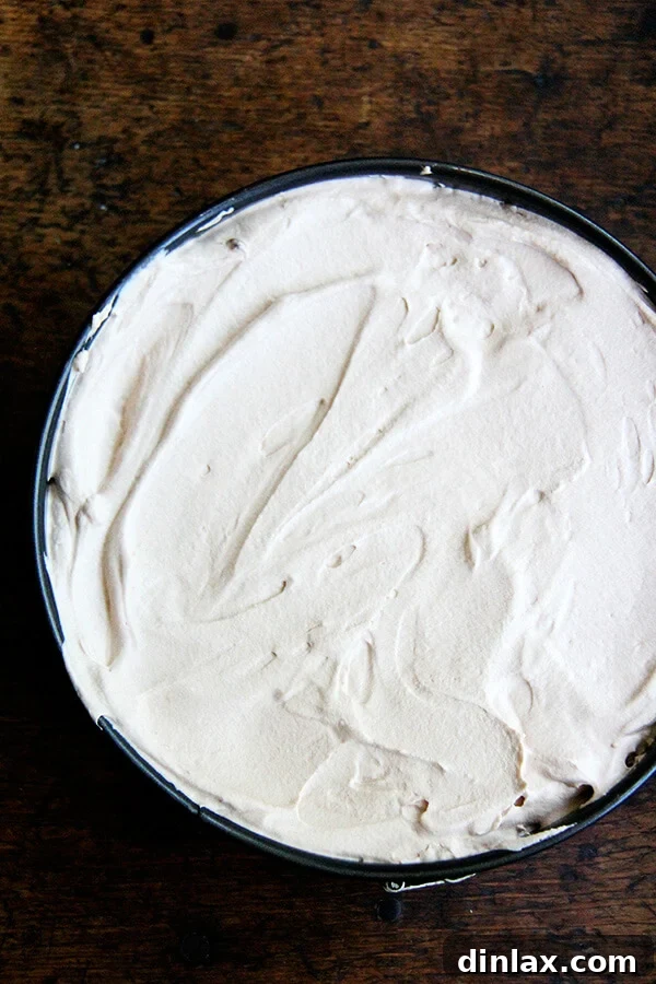 Applying the final, smooth top layer of creamy mocha mixture over the softened chocolate wafers in the delicious Chocolate-Espresso Icebox Cake.