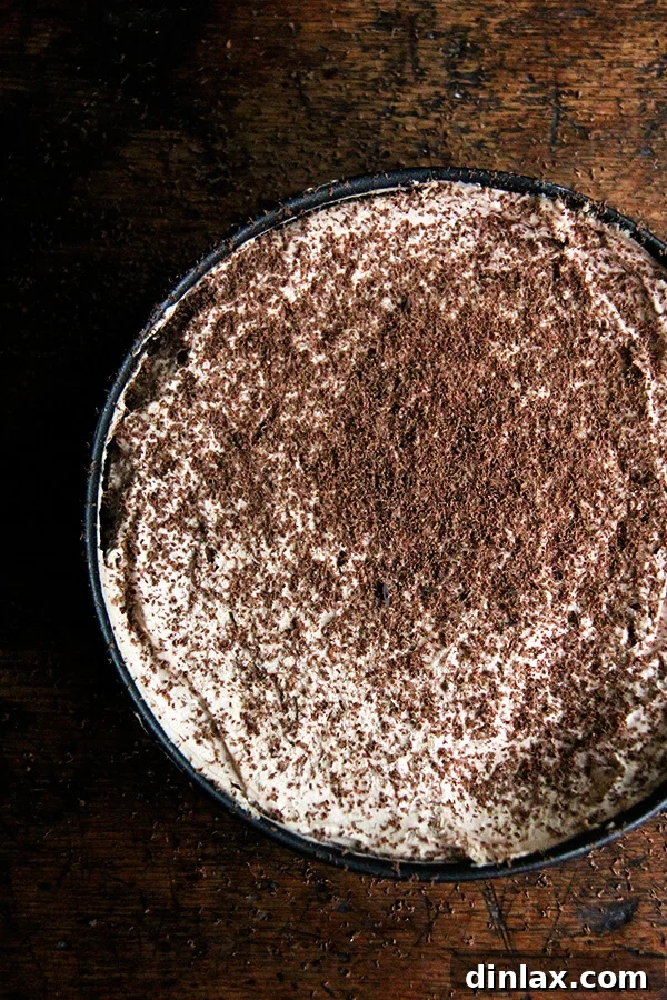 Garnishing the chilled Chocolate-Espresso Icebox Cake with delicate curls of shaved bittersweet chocolate, adding an elegant finish.