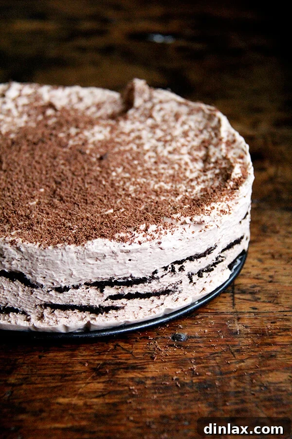 A stunning slice of the Chocolate-Espresso Icebox Cake, revealing soft layers of chocolate wafers and creamy espresso-infused mascarpone, a truly irresistible no-bake dessert.