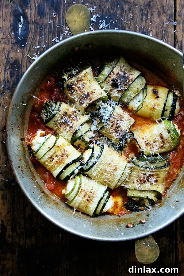 A beautifully arranged pan of golden zucchini involtini, ready to be served.