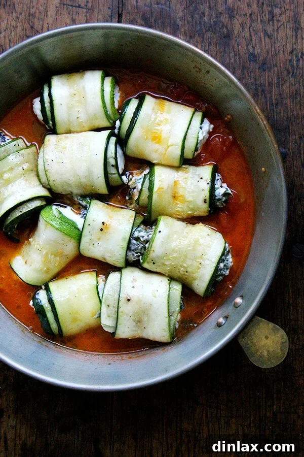 Zucchini involtini perfectly arranged in a baking dish, awaiting the oven.