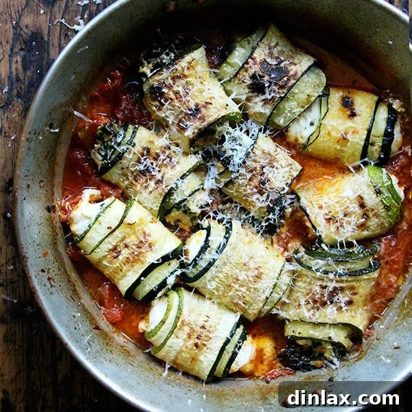 A dish of Zucchini Involtini with fresh tomato sauce and herbs.