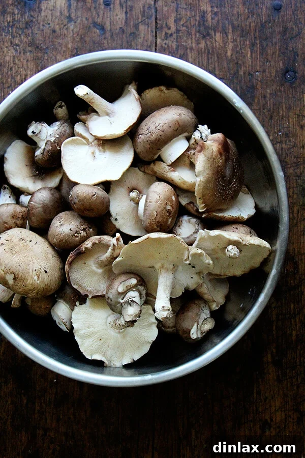 A vibrant assortment of fresh mushrooms, including earthy shiitake and robust cremini, ready for roasting.