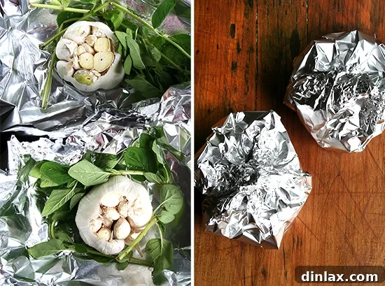 Several foil pouches, each carefully sealed, containing whole garlic heads and aromatic fresh oregano sprigs, prepared for baking.
