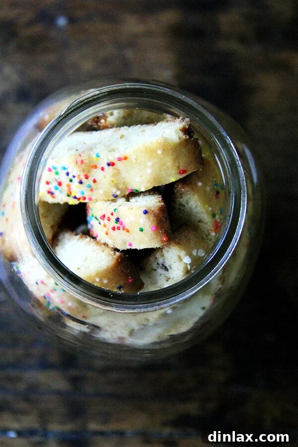Indulge in Mandel Bread with Marzipan & Sea Salt: A Twice-Baked Almond Cookie Delight Delicious Mandel bread with marzipan and sea salt, adorned with sprinkles, in a glass jar.