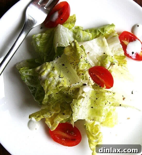 A bowl of creamy blue cheese dressing garnished with fresh parsley.