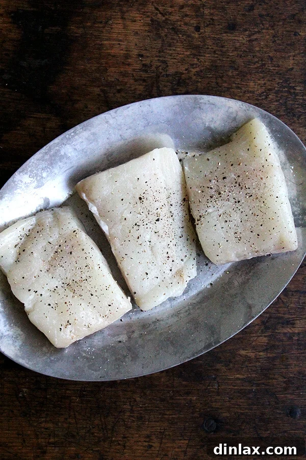 Halibut fillets coated with lemon-caper mayonnaise mixture, ready for pan-broiling.