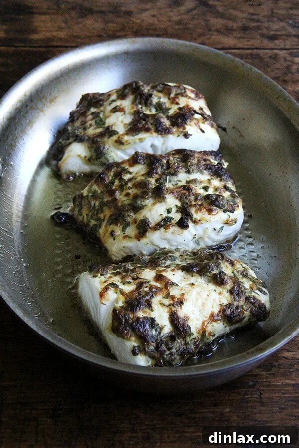 Pan-broiled halibut with a golden, crispy crust fresh out of the oven.