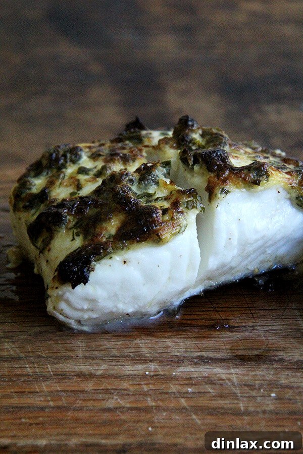 Detailed shot of the pan-broiled halibut's crispy, flavorful lemon-caper crust.
