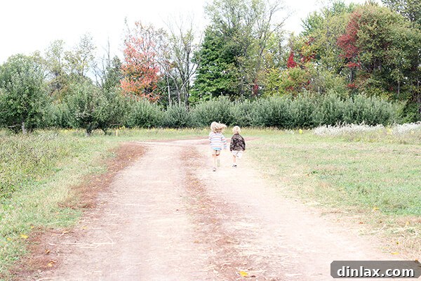 Two children, Ella and Graham, posing happily at the orchard.