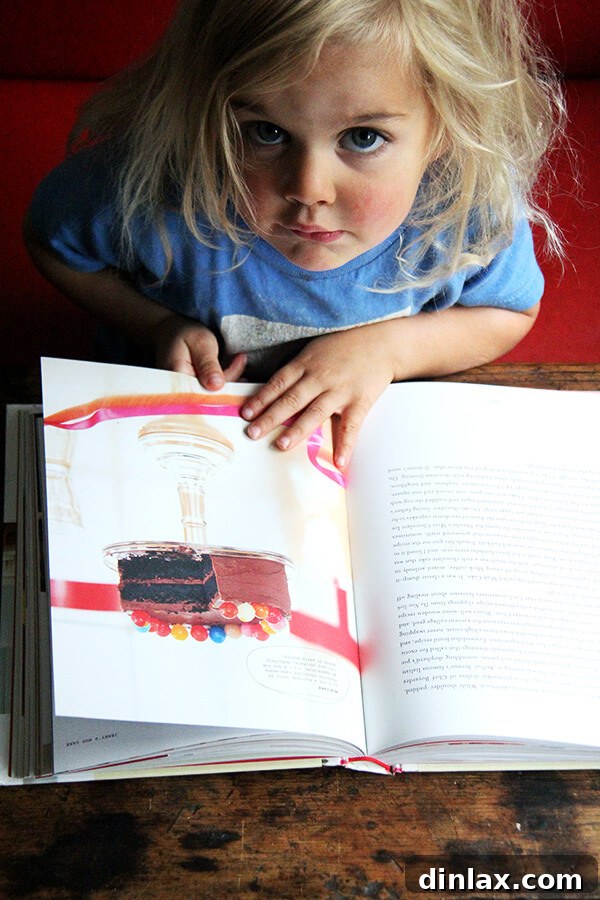 Wren happily holding and reading the book.