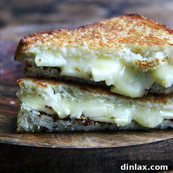 A vibrant grilled apple, cheddar, and mustard sandwich, ready to be enjoyed.