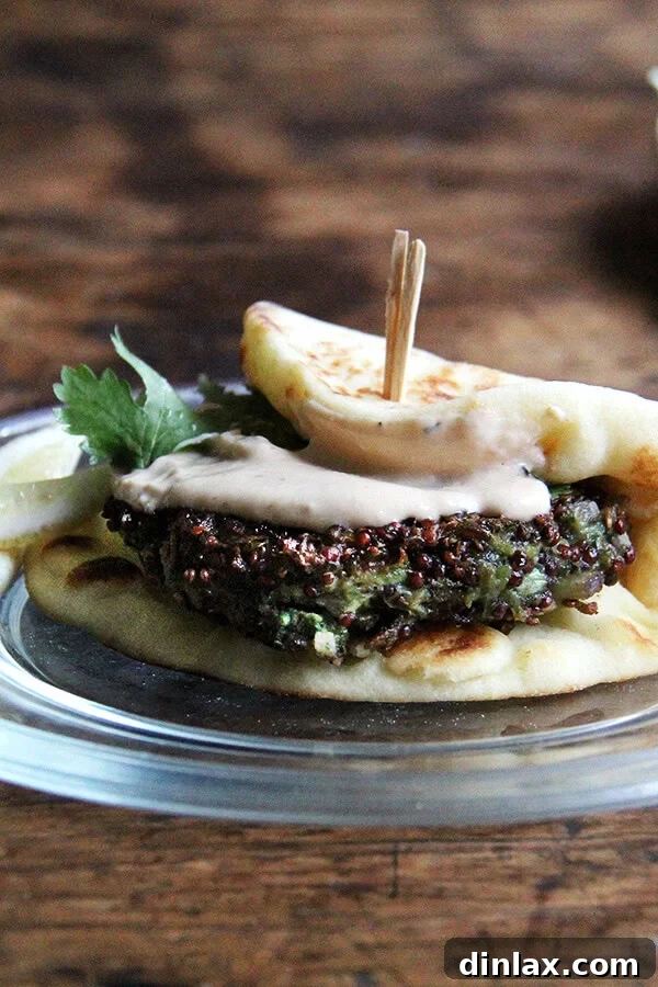 A plate of crispy quinoa cakes with tahini sauce and fresh herbs, ready to be served.