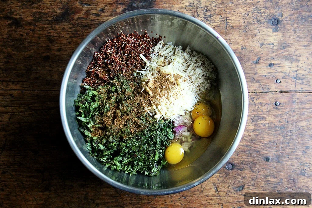 A large bowl filled with the vibrant green quinoa cake mixture, showing cooked quinoa, chopped greens, and other ingredients.