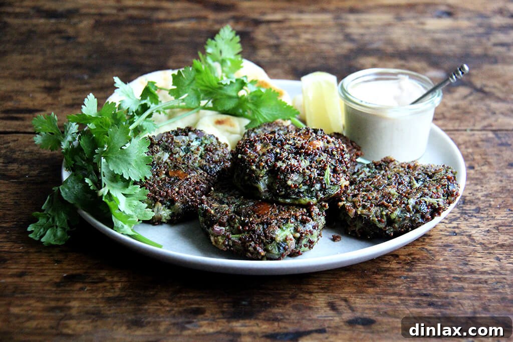 A platter of golden-brown crispy quinoa cakes with mustard greens, garnished with fresh herbs.