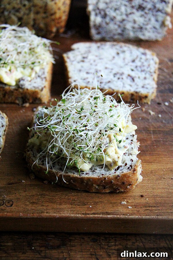 Assembling the curried apple-egg salad toasts, showing the bread slices being topped generously with the colorful salad mixture.