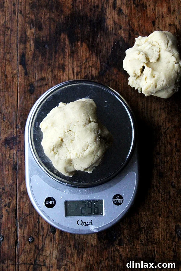 Dorie Greenspan's Classic Vanilla Bean Sablés 7 Another image of sablé cookie dough on a scale, emphasizing accuracy in baking.
