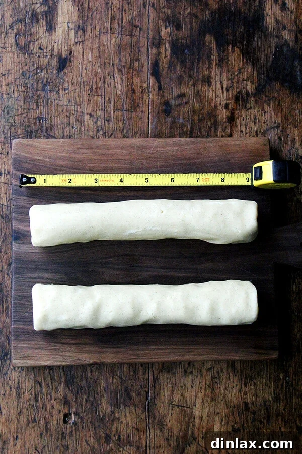 Dorie Greenspan's Classic Vanilla Bean Sablés 8 Two neatly shaped 9-inch logs of sablé cookie dough resting on a cutting board, prepared for chilling.
