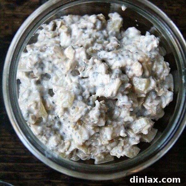 A bowl of homemade apple pie overnight oats, garnished with toasted pecans and a sprinkle of cinnamon.