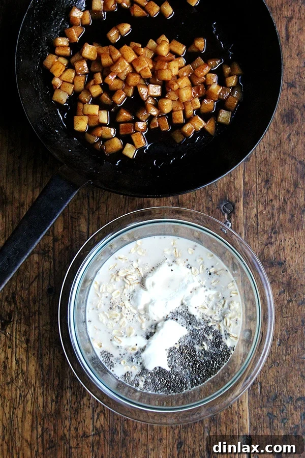 Close-up of raw rolled oats and a fresh apple, showcasing the key components before preparation.