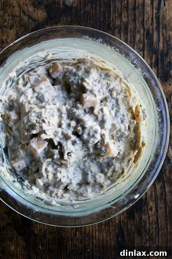 A beautifully presented bowl of apple pie overnight oats, ready to be enjoyed, garnished with pecans and extra cinnamon.