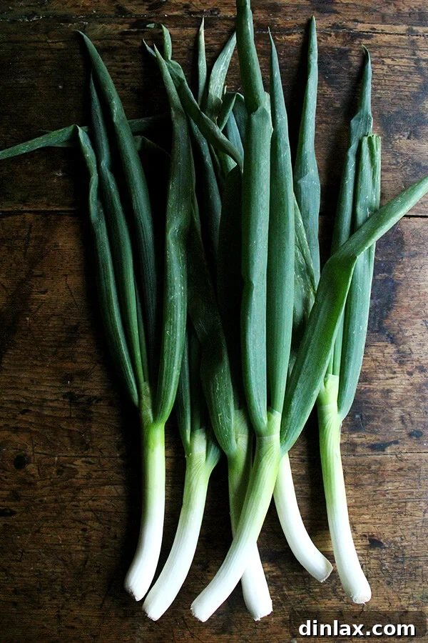 Sunny Lemon Leek Bucatini Skillet 2 Fresh leeks being prepared for cooking, highlighting their vibrant green and white parts.