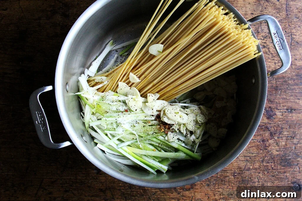 Sunny Lemon Leek Bucatini Skillet 5 Ingredients for one-pan bucatini laid out in a pan before cooking, showing the starting stage of the recipe.
