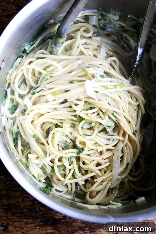 Sunny Lemon Leek Bucatini Skillet 6 Bucatini and other ingredients simmering in a pan, capturing the cooking process and the developing sauce.