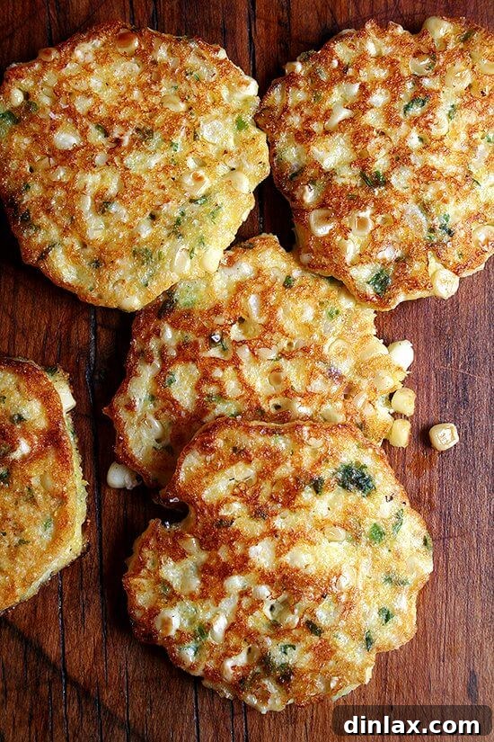 Platter of golden crispy corn fritters, ready to be served. Ideal as a main course with a fresh salad or a delicious side dish.