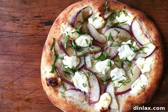 Classic Margherita Pizza with Marcella Hazan's Signature Tomato Sauce and House-Made Ricotta 11 A closer look at a slice of the nectarine and ricotta pizza, highlighting the vibrant colors and fresh ingredients.