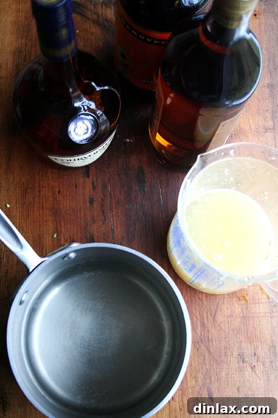 A large pot positioned beside the ingredients for Fish House Punch, ready for mixing the components.