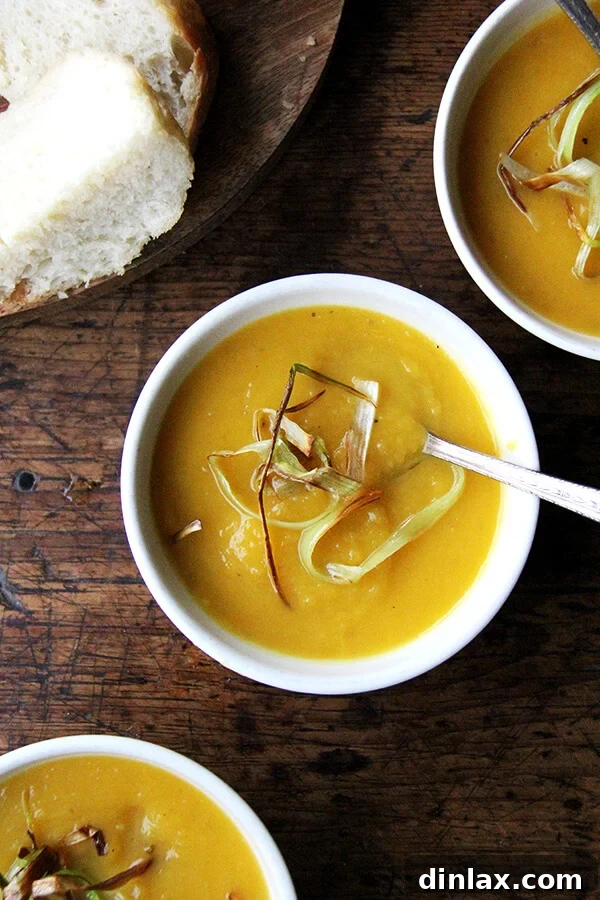 Autumn Glow Butternut Apple Slow Cooker Soup 8 Bowls of butternut squash and apple soup topped with crispy leeks.