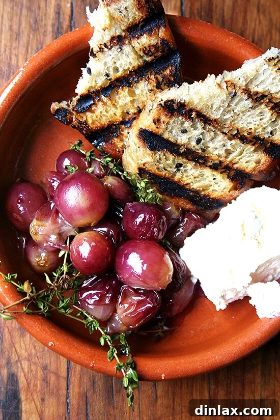 Close-up of thyme-roasted grapes with homemade ricotta and grilled bread, showcasing the vibrant colors and appealing textures of this gourmet appetizer.