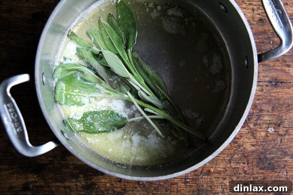 Golden Butternut and Sage Penne Bake 4 A close-up shot of melted butter with fresh sage leaves sizzling in a pot.