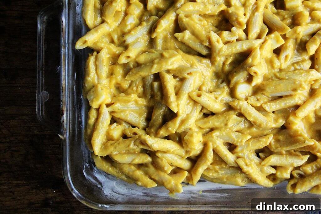 Golden Butternut and Sage Penne Bake 8 A 9x13-inch baking pan, buttered and filled with the penne, butternut squash sage sauce, and cheese mixture, ready for the oven.