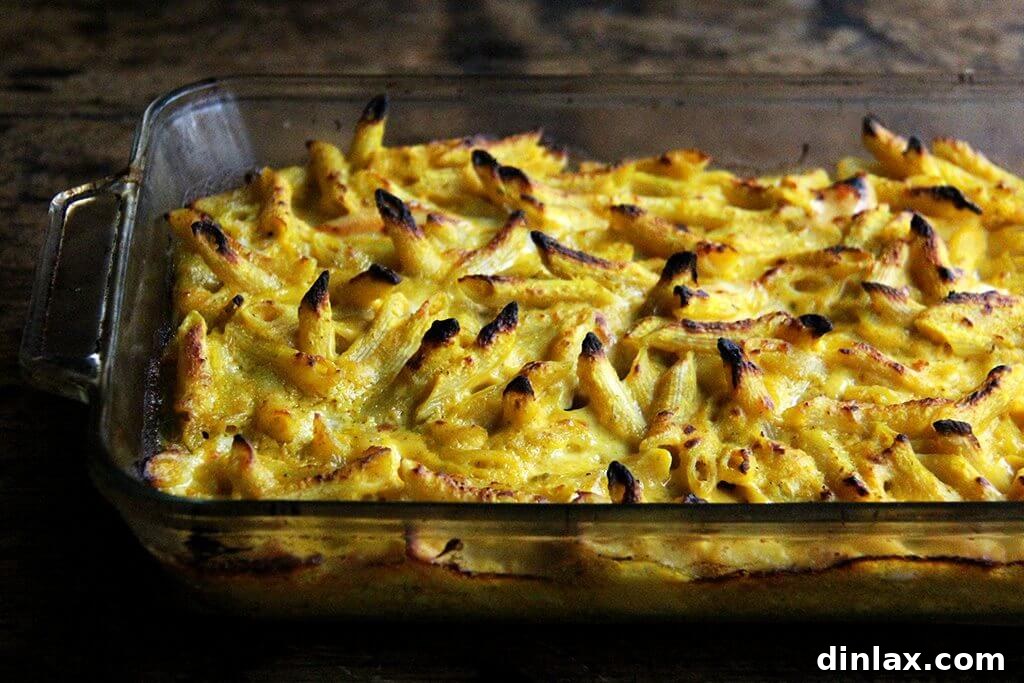 Golden Butternut and Sage Penne Bake 9 Freshly baked penne with butternut sage sauce, bubbling and golden-brown straight from the oven, with crispy edges.