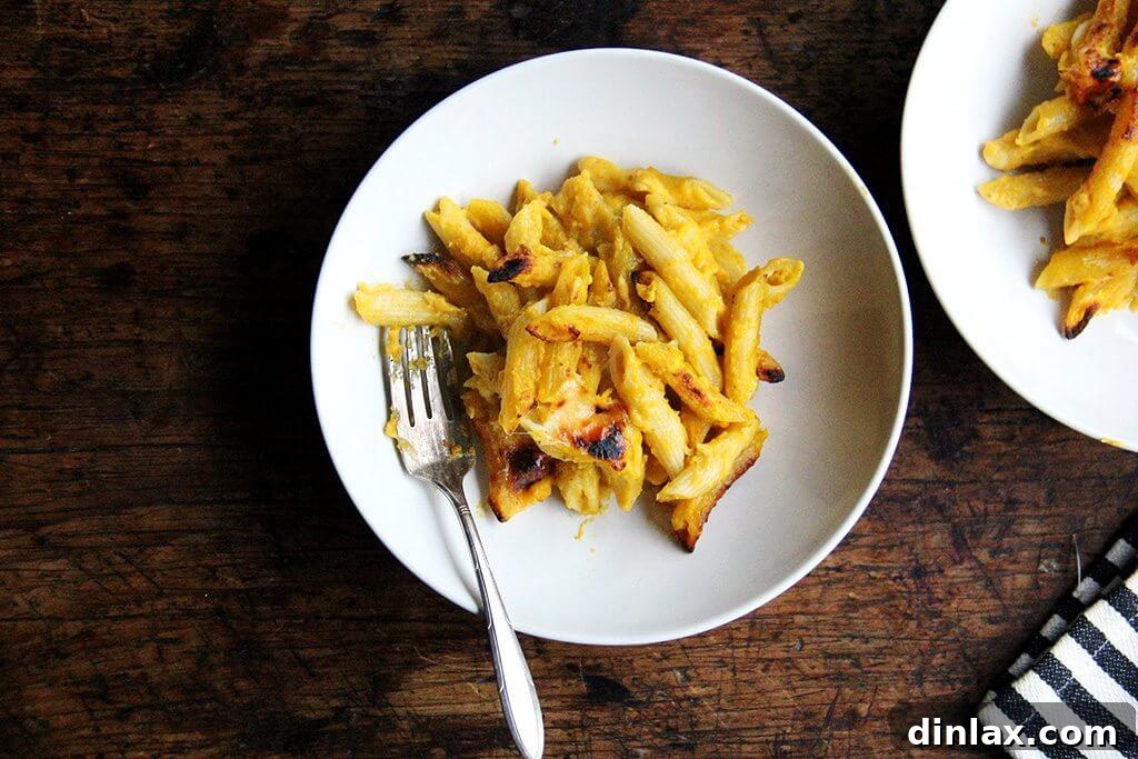 Golden Butternut and Sage Penne Bake 10 Two individual bowls of baked penne with butternut sage sauce, garnished with fresh sage, ready to be enjoyed.