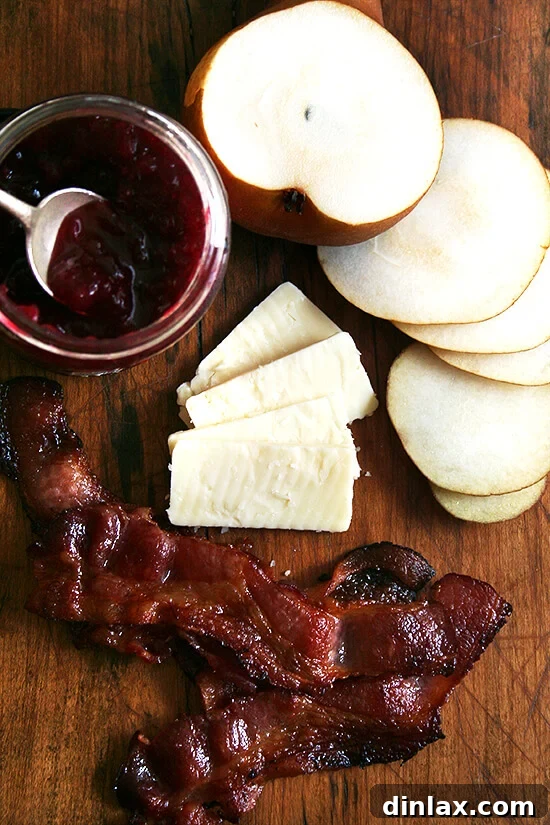 Fresh ingredients for a bacon, cheddar, and pear panini displayed on a counter